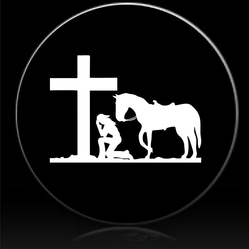 Cowgirl praying at cross spare tire cover
